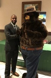 Johnny Boggs shakes hands with Smokey Bear 
