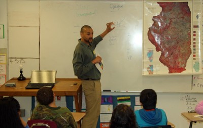 Students in a classroom watching a presentation on Science in Action Day